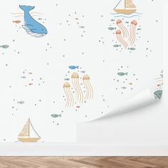 a wall with some animals and boats on it in the room next to a paper roll