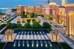 an aerial view of the palace hotel in abu, united arab emirates is lit up at night