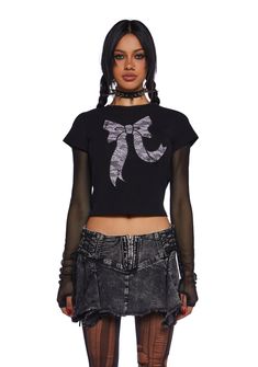 This graphic tee has a stretchy knit construction, short sleeves, and a textured lace bow graphic on the front with stud detailing. Y2k Crew Neck T-shirt For Night Out, Fitted Lace Top T-shirt With Crew Neck, Edgy Black T-shirt For Party, Alternative Fall T-shirt, Edgy Stretch T-shirt For Night Out, Fitted Lace Top T-shirt With Short Sleeves, Fitted Lace Top Crew Neck T-shirt, Fitted Lace Top Short Sleeve T-shirt, Fitted Grunge T-shirt For Night Out