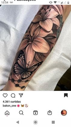 a woman's arm with flowers and butterflies on it