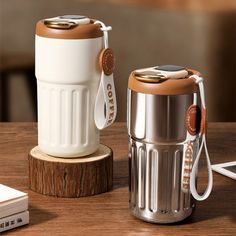 a white and brown coffee cup sitting on top of a wooden table next to a charger