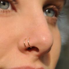 a close up of a person's nose with an ear piercing on it and the words ebay written below