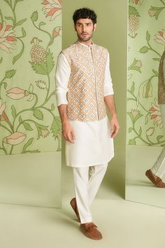 Ivory cotton silk embroidered bundi in applique and resham work. Paired with solid pant and kurta.
Component: 3
Pattern: Embroidered
Type Of Work: Applique work, Resham work
Neckline: Mandarin collar
Sleeve Type: Full sleeves
Fabric: Cotton silk
Color: White
Other Details: 
Embroidered placket kurta
Occasion: Reception - Aza Fashions White Fitted Cotton Silk Bandhgala, Spring Sherwani With Gota Work, Spring Wedding Sherwani With Gota Work, Eid Cotton Silk Nehru Jacket With Gota Work, Traditional White Cotton Silk Bandhgala, Eid Nehru Jacket With Gota Work In Cotton Silk, White Cotton Silk Bandhgala With Resham Embroidery, White Kurta With Gota Work For Spring, Designer Long Sleeve Nehru Jacket With Gota Work