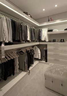 a walk in closet filled with lots of clothes