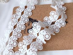 a cork board with white lace on it