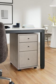 an office desk with two drawers and a chair