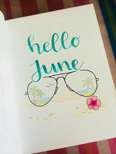 an open book with sunglasses and the words hello june written in blue ink on it