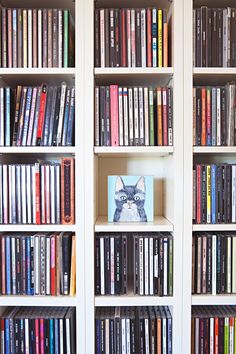 a bookshelf filled with lots of different types of dvd's and dvds