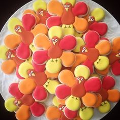 decorated cookies in the shape of turkeys on a plate