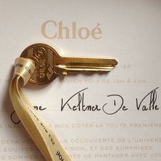 a gold key with a ribbon attached to it