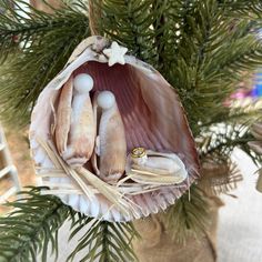 Seashell Nativity Ornament - Coastal Christmas Charm Celebrate the holiday season with a unique twist on a classic tradition with our Seashell Nativity Ornament. Handcrafted with care, this enchanting ornament features a detailed nativity scene created from delicate seashells, bringing a touch of coastal elegance to your Christmas décor. Features: Artisan Craftsmanship: Each ornament is meticulously handcrafted using a variety of seashells, creating a stunning and unique nativity scene that reflects the beauty of the sea. Festive and Elegant: Perfect for adding a coastal touch to your holiday decorations or as a special gift for those who love both Christmas and the beach. Versatile Display: Ideal for hanging on your Christmas tree, displaying in a holiday arrangement, or using as a charmi Sea Shell Nativity Scene, Seashell Christmas Wreath, Seashell Nativity, Seashell Ornaments Diy, Seashell Ornament, Seashell Christmas Ornaments, Beach Christmas Ornaments, Coastal Crafts, Religious Ornaments