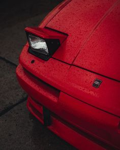 the front end of a red sports car