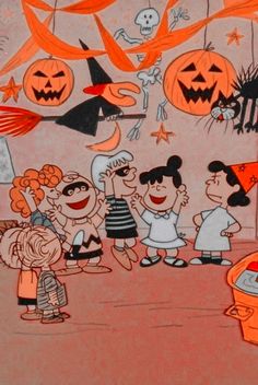 a group of children standing in front of halloween decorations