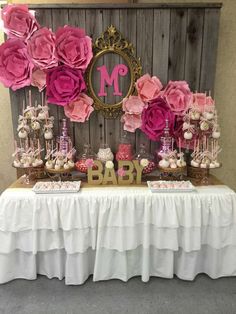 the baby shower is decorated with pink flowers