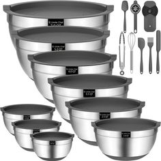 a set of six stainless steel mixing bowls with measuring spoons and utensils