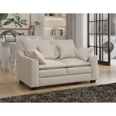 a white couch sitting on top of a wooden floor