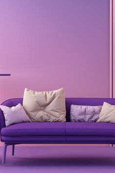 a purple couch sitting in front of a wall with two white pillows on top of it