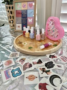 a wooden tray topped with lots of stickers next to a vase filled with flowers