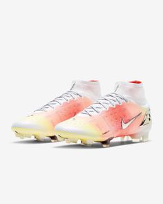 the nike vapor merance football shoe is shown in white and pink tones with orange accents