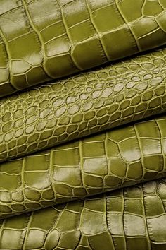 green crocodile leather upholsters stacked on top of each other