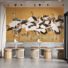 there are many birds painted on the wall in this restaurant, and it looks like they're dancing