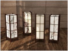 four tall glass vases sitting on top of a wooden floor