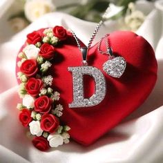 a red heart with flowers and a diamond d on it