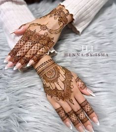 two hands with henna designs on them