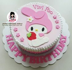 a pink and white birthday cake with an animal on it