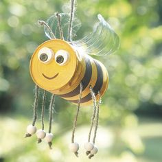 a close up of a toy bee on a string