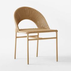 a chair made out of wicker sitting on top of a white floor