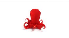 an origami red object on a white background