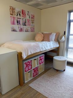 a bedroom with a bed, desk and storage bins on the bottom bunk beds