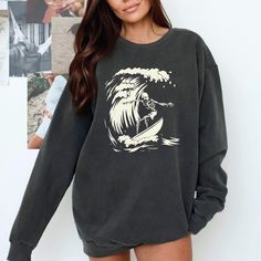 Surfer Ghoul Sweatshirt - Ride the Waves of Style This Halloween and Beyond! 🌊 Are you ready to catch some serious style this season? Dive into the spirit of Halloween with our Surfer Ghoul Sweatshirt, where the laid-back vibes of surfing meet the playful spookiness of the season! This isn't just any sweatshirt; it's your new go-to piece that combines comfort, uniqueness, and a whole lot of character. 🧵 Product Features: Premium Fabric: Made from 80% ring-spun cotton and 20% polyester, our swe Grunge Long Sleeve Sweatshirt For Fall, Fall Grunge Long Sleeve Sweatshirt, Grunge Crew Sweatshirt For Winter, Casual Sweatshirt With Screen Print, Casual Long Sleeve Screen Print Sweatshirt, Halloween Streetwear Crew Tops, Oversized Band Merch Long Sleeve Sweatshirt, Grunge Long Sleeve Sweater With Graphic Print, Grunge Crew Neck Sweatshirt For Winter