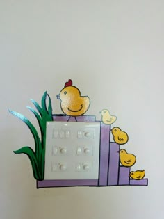 a yellow duck sitting on top of a computer keyboard with rubber ducks around the keyboard