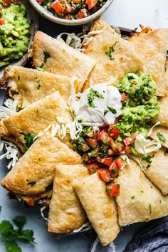 tortillas with guacamole, salsa and sour cream on the side