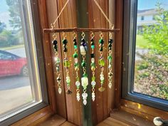 a wind chime hanging from the side of a window