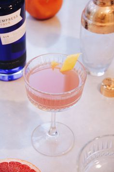 a grapefruit cocktail garnished with an orange slice