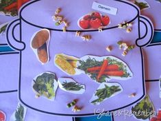 an assortment of vegetables cut out on a purple surface with words and pictures attached to them