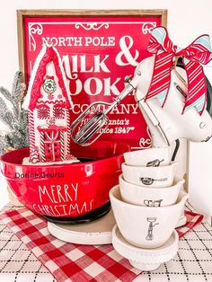 a red and white christmas themed kitchen set on a checkered table cloth next to a sign