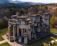 an aerial view of a building made out of concrete blocks in the middle of a grassy area