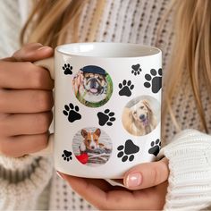 a woman holding a coffee mug with dogs on it