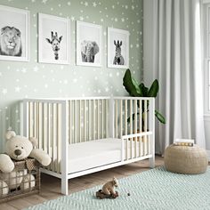 a baby's room with green walls and pictures on the wall, including a crib