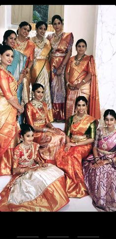 a group of women in saris posing for a photo