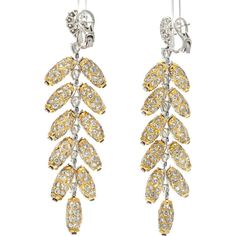 Celebrate the symphony of artistry and elegance in these 18K Two Tone 48.00 carat total weight Diamond Feather Dangling Earrings from our Estate Collection. These earrings are a free-spirited creation, capturing the beauty and all the glam of the peacock's feather motif in intricately detailed 18K yellow gold diamond jewels. Adorned with 2 center diamonds weighing 1.10 carats, 14 additional diamonds totaling 5.67 carats, and over 500 smaller diamonds approximating 42 carats, these earrings are a dazzling spectacle.The design of these earrings showcases a dramatic pendant feather style, making them a statement piece for any occasion. With a length of 3.6 inches and a width of 1 inch, they gracefully dangle and catch the light, highlighting their exquisite craftsmanship and attention to deta Luxury Yellow Gold Clip-on Diamond Earrings, Luxury White Gold Clip-on Diamond Earrings, Yellow Gold Diamond Clip-on Earrings For Evening, Luxury Clip-on Diamond Earrings For Formal Occasions, Luxury Clip-on Diamond Earrings For Formal Events, Luxury Formal Clip-on Diamond Earrings, Formal Yellow Gold Chandelier Earrings With Diamond Accents, Formal Yellow Gold Diamond Chandelier Earrings, Luxury Yellow Gold Dangle Clip-on Earrings