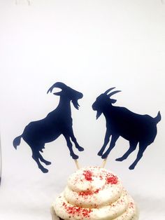 two cupcakes with red sprinkles and black silhouettes on them