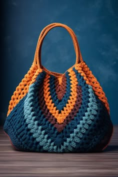 a crocheted bag sitting on top of a wooden table next to a blue wall