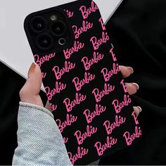 a person holding an iphone case with the name barbie on it and pink letters all over them