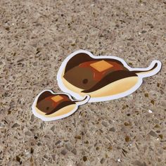 two stickers on the ground that look like they are floating in the ocean or sea