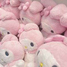 a pile of hello kitty stuffed animals sitting next to each other